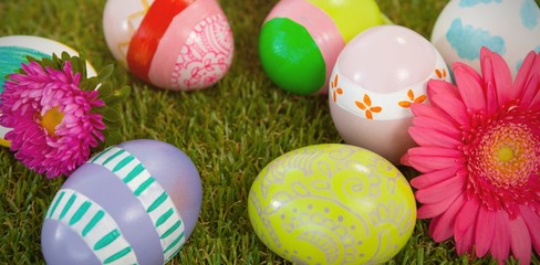 Painted easter eggs with flower on grass