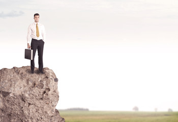 Happy salesman on cliff in the country