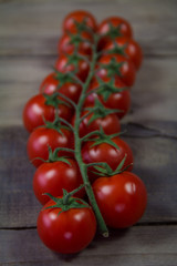 Fresh cherry tomatoes on wooden background