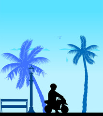 Boy rides on a motorcycle toy on the beach, one in the series of similar images silhouette