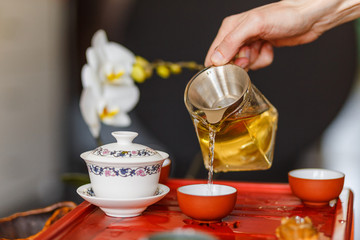 The tea ceremony. The hands of man pouring tea.