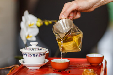 The tea ceremony. The hands of man pouring tea.