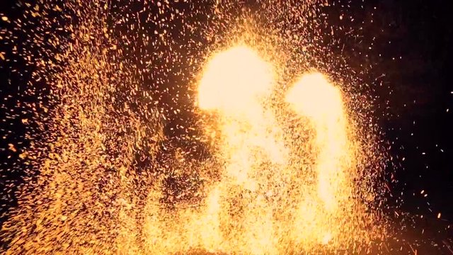 Slow motion. Spinning firework wheel, sparkles all around. Fire show. Fireworks.