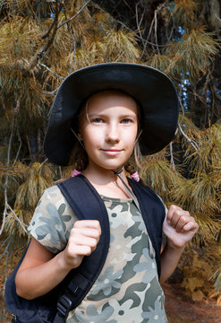 A teenage girl is traveling through the forest