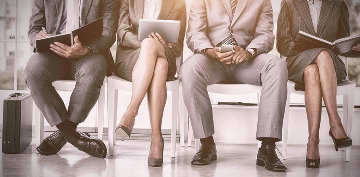 Business people waiting to be called into interview