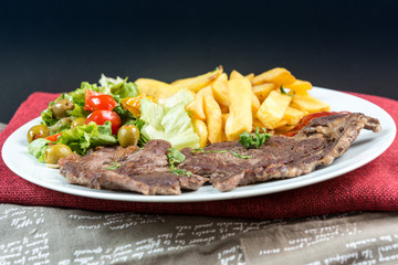 juicy steak beef meat with tomato and french fries