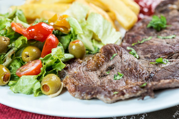 juicy steak beef meat with tomato and french fries