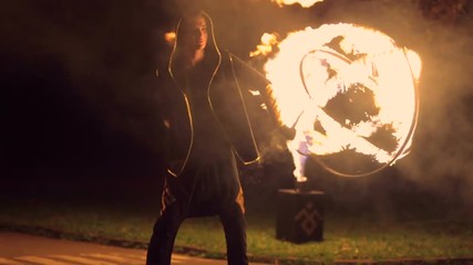 The man turns in his hands a ball of fire. Great fire show. Slow motion.