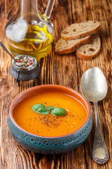 Delicious carrot soup with spices and Basil. Vegetarian diet food. Selective focus