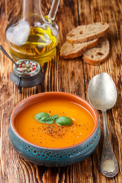 Delicious carrot soup with spices and Basil. Vegetarian diet food. Selective focus
