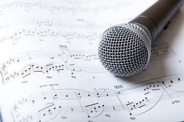 microphone lies on the music book