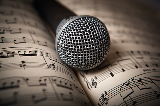 microphone lies on the music book