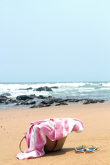 Fototapeta na wymiar Towel,beach bag and slipper in beach.