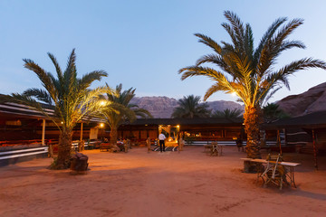 Bedouin restaurant with palm trees in Wadi Rum desert, Jordan