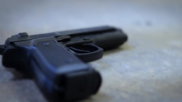A handgun or pistol lying on grunge basement floor