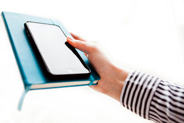 Woman using mobile smartphone. Modern or business concept. Close-up corporate smartphone approach.