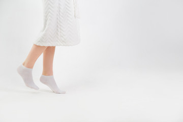 Feet of woman going on tiptoe at home