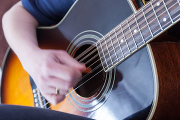Fototapeta na wymiar hand playing on an acoustic guitar