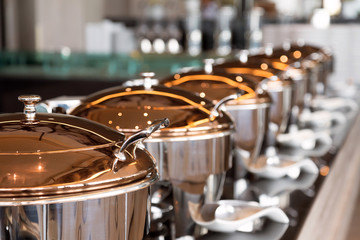 heating trays on the buffet line ready for service. breakfast and lunch buffet food catering...