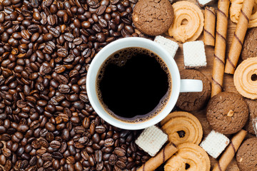 black coffee in white cup with cookie and dessert