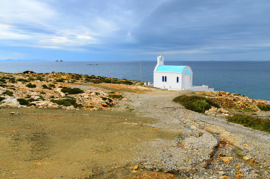 Traditional greek white church on rocky coastline on the Paros Island, Cyclades. Greece.