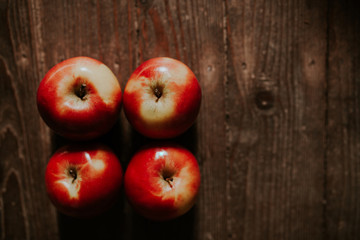 Bio apples on vintage wooden background. Fresh red apples. Top view.