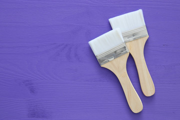 paint brushes on purple background