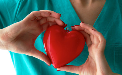 Dr. gently holding a heart on white background