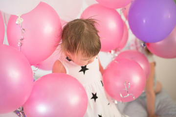 Fototapeta na wymiar Crazy Toddler with balloons, children's holiday