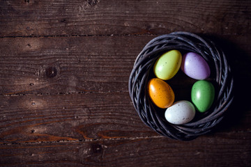 Easter eggs on wooden background. Can be personalized with your message for a festive Easter card.