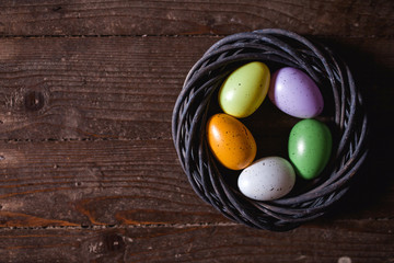 Easter eggs on wooden background. Can be personalized with your message for a festive Easter card.
