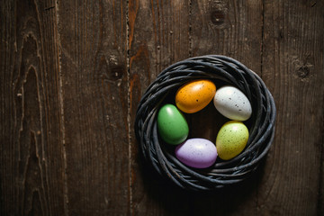 Easter eggs on wooden background. Can be personalized with your message for a festive Easter card.