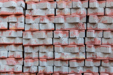 A stack of new bricks gray with red painting