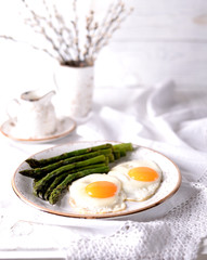 Fried asparagus with eggs. Healthy breakfast.