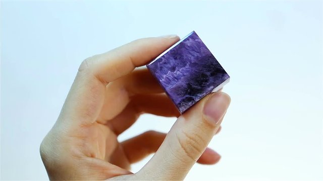 Charoite &ndash; Purple Violet silicate mineral. Jeweler holding Charoite