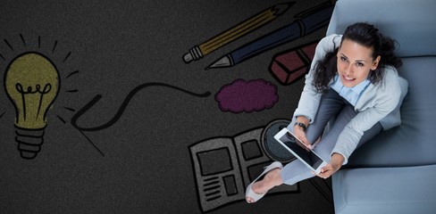 Composite image of woman on her tablet looking up