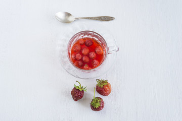 cup of strawberries compote top view on white background