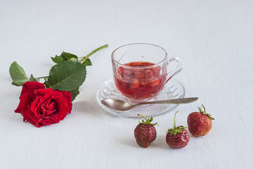 summer concept/cup of strawberries compote and several strawberries on white background