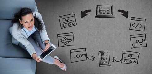 Composite image of woman on her tablet looking up