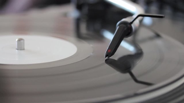 Close up footage of a spherical needle on a rotating vinyl, the shot is moving from right to left...
