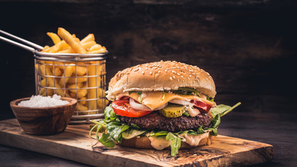 Fototapeta Burger with fries on wooden obraz