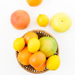 Lemon, orange, grapefruit and mandarine in a plate on white background. Flat lay, top view. Fruit's background