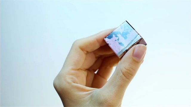 Rhodonite (manganese inosilicate). Jeweler holding pink Rhodonite.