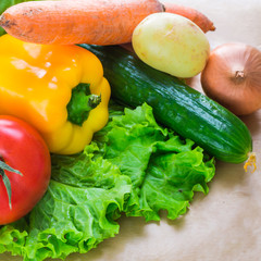 fresh vegetables. Tomatoes, potatoes, cucumber, peppers, onions, lettuce, carrots, cabbage on a table
