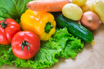 fresh vegetables. Tomatoes, potatoes, cucumber, peppers, onions, lettuce, carrots, cabbage on a table