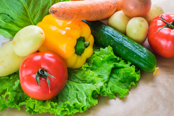 fresh vegetables. Tomatoes, potatoes, cucumber, peppers, onions, lettuce, carrots, cabbage on a table