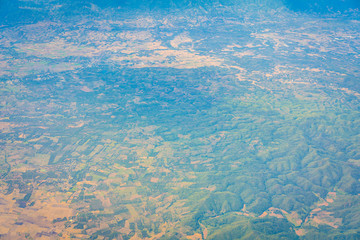 Naklejka premium Mountains under clouds. View from the airplane .