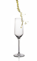 Splash of white wine in glass with reflection