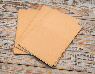 Recycled paper book on wood background .