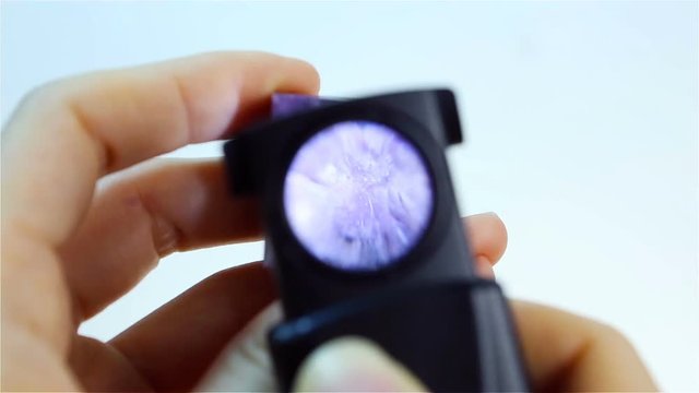 Charoite &ndash; Purple Violet silicate mineral. Jeweler holding Charoite